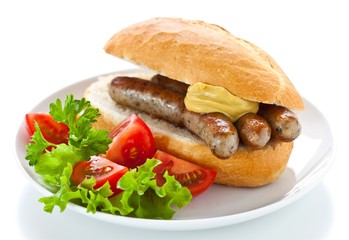 Nuremberg bratwurst in bread roll with mustard and salad - 33649782
