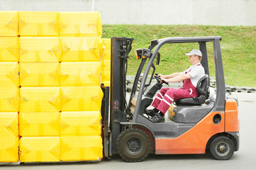 worker driver at warehouse forklift loader works