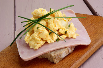 Rührei mit Schnittlauch auf Brot mit gekochtem Schinken