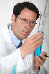 Scientist looking at test-tube