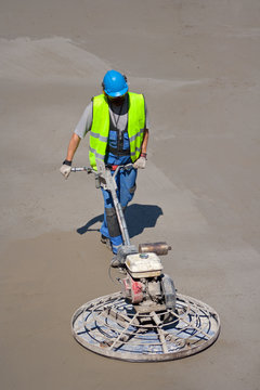 Power Trowel Machine And Construction Worker