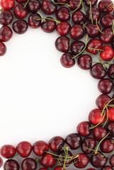 Cherry border in shape of heart on white background