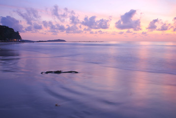 Sunrise on violet sky and beach