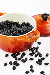 Black beans in bowl isolated on white