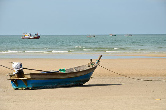 Blue fishing boat on sand