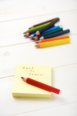 pencil and postit with back to school text