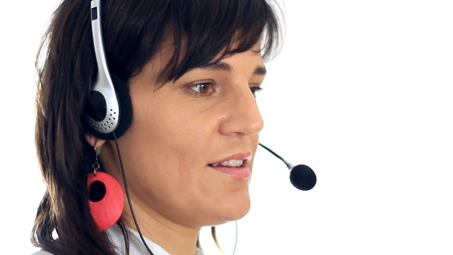 Attractive helpdesk consultant talking on headset, isolated