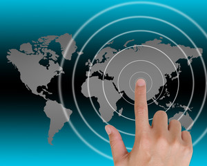 Hand pushing a button on a touch screen interface in wide world.