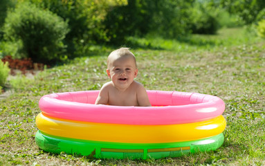 Happy baby swimming  in   pool