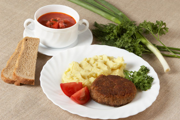 Cutlet with mashed potatoes and soup