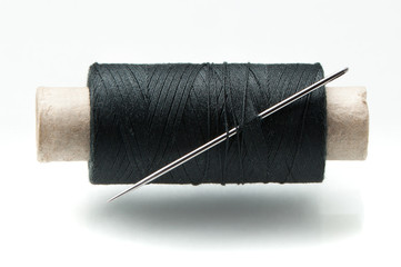 The coil of threads with a needle