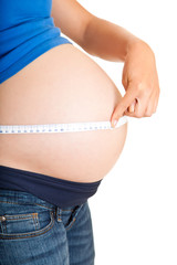 Pregnant woman measuring stomach isolated on white