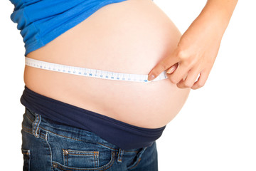 Pregnant woman measuring stomach isolated on white