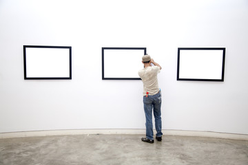 Gallery Worker arranging Frames
