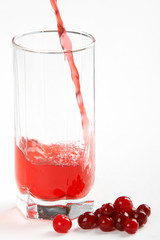 In a glass pours the cranberry juice