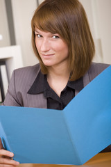 woman reading application file