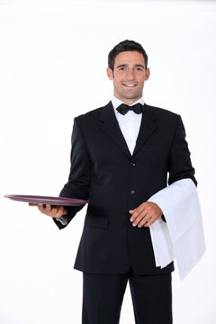 well dressed waiter facing the camera