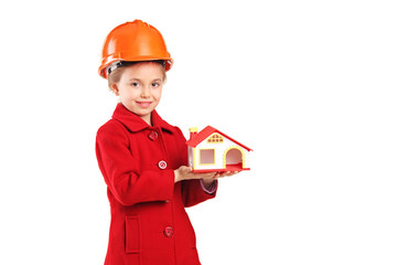 A child with helmet holding a model house