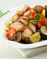 Rustic roast pork with vegetables,mushrooms and herbs