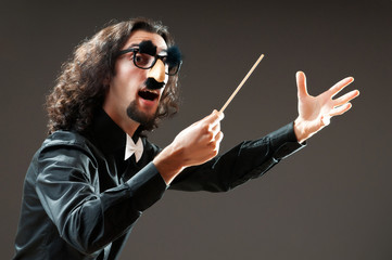 Funny conductor against dark background