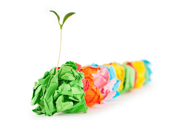 Paper recycling concept with seedlings on white