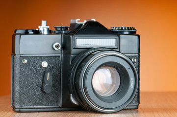 Vintage film camera against gradient background