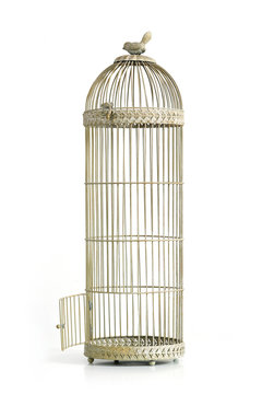 Vintage bird cage with open door over white background.