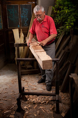 woodcarver working with mallet and chisel