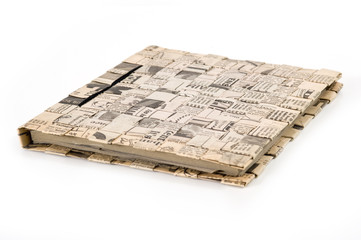 Diary book on white background. Cover made by old newspaper.
