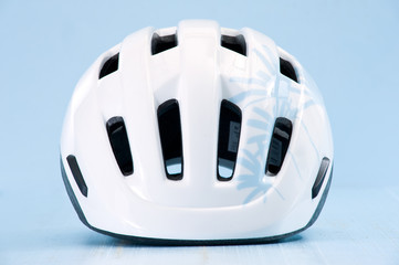 Fototapeta premium White bike helmet isolated on blue background. Front view.