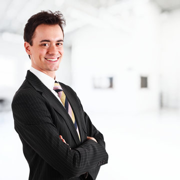 Happy young businessman smiling