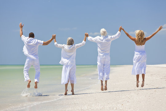 Four People, Two Seniors, Family Couples, Jumping On Beach