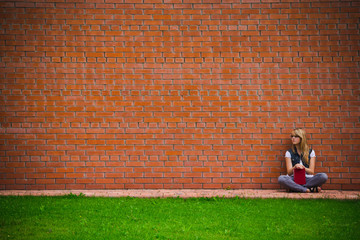 beautiful girl at a brick wall