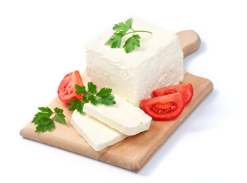 White Bulgarian cheese, arranged with tomatoes and parsley on cu