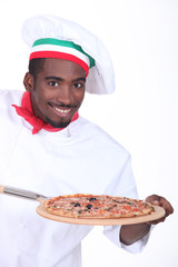 Chef with pizza on a wooden peel