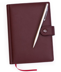 brown red leather notebook with pen on white background