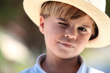 Closeup of a young boy in a straw hat