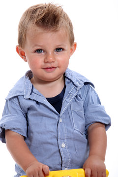 Closeup of a little boy with gelled hair using a walker