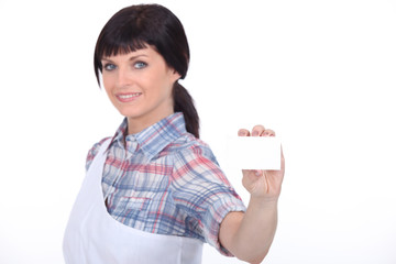 female butcher showing a business card