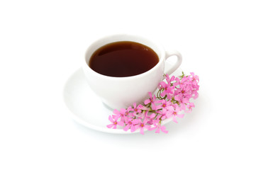 A cup of black coffee with flowers