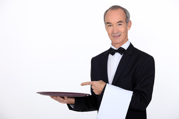 Waiter pointing to a tray