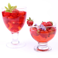 Jelly with strawberries in glass cups on white background