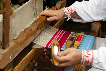 wooden loom with weaver