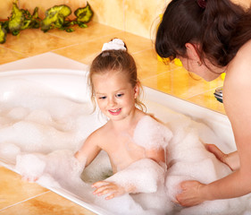 Mother and daughter  washing in bath.