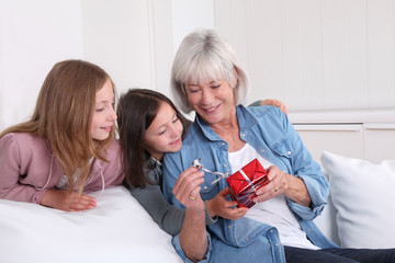 Girls offering present to grandmother