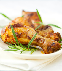 Roasted chicken legs with rosemary sprigs