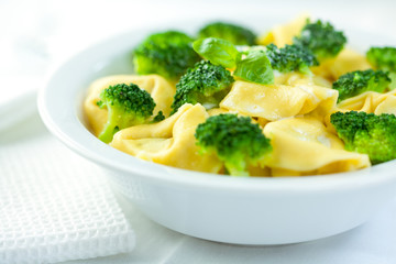 Closeup of tortellini with broccoli