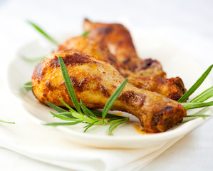 Roasted chicken legs with rosemary sprigs