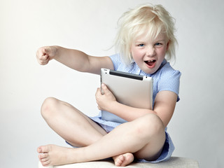 Cute little girl has a lot of fun with her touchpad