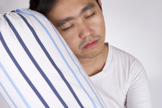 sleepy head, male model sleep on blue stripe bolster.